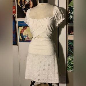 White eyelet mini dress with tie back and puffed ruffly sleeves